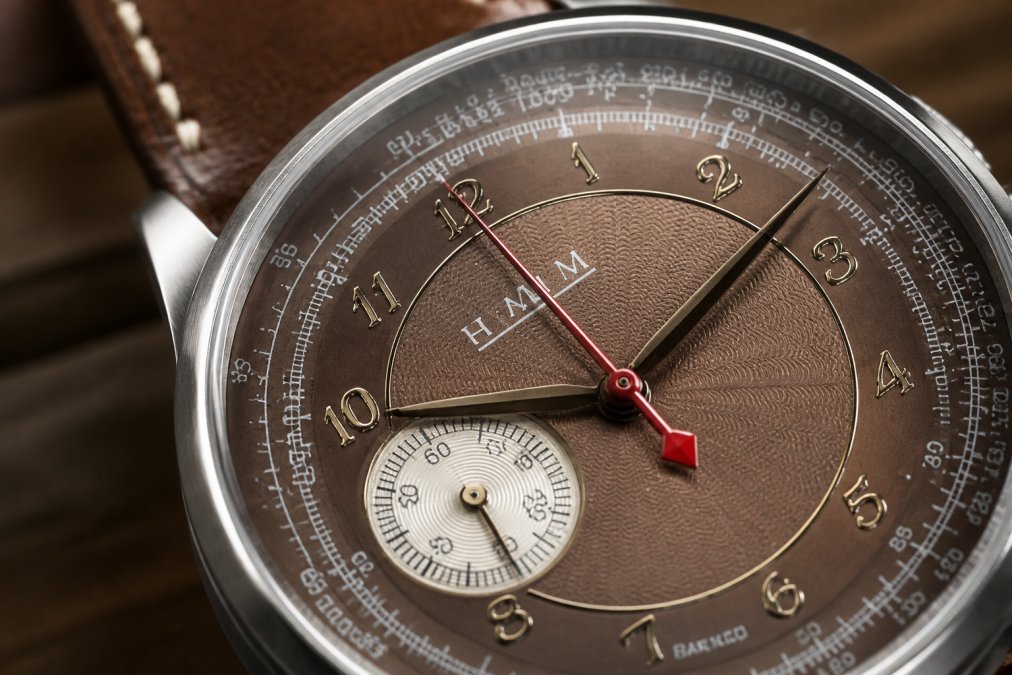 Close-up macro photograph of a guilloché dial showing intricate rose engine patterns with light reflecting across the textured surface, revealing depth and precision of the hand-finished work