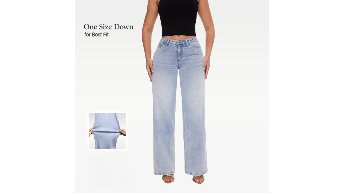 A woman wearing high-waisted wide leg jeans and a tucked-in blouse, standing in a bright modern office, showing a polished work-to-weekend outfit