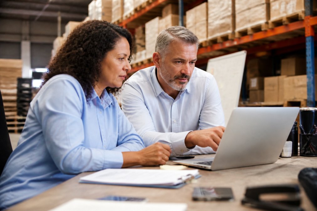 Operational AI consultants analyzing warehouse inventory and labor data on a dashboard infographic