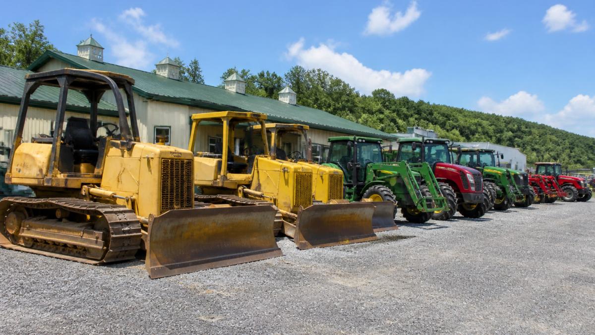 Used crawler dozers and farm tractors at Hollinger and Son Equipment Sales in Pennsylvania on a gravel lot