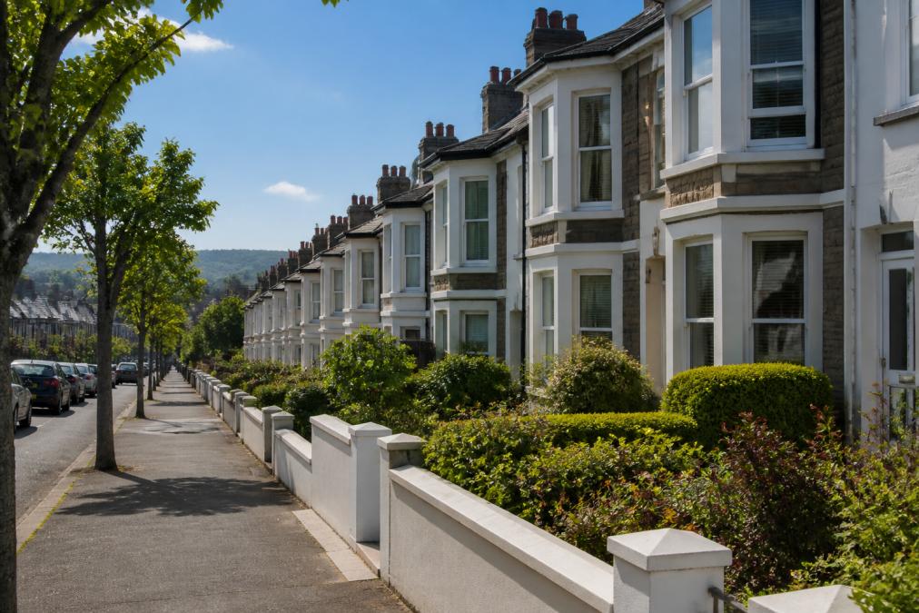Visual roadmap for A quiet residential street in a British coastal city, showing a row of well-maintained terraced h...