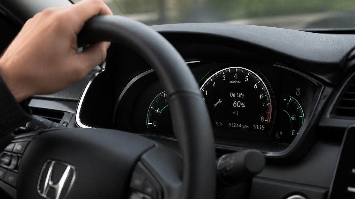 Dashboard display showing oil life and service codes for a Honda specific maintenance schedule process.