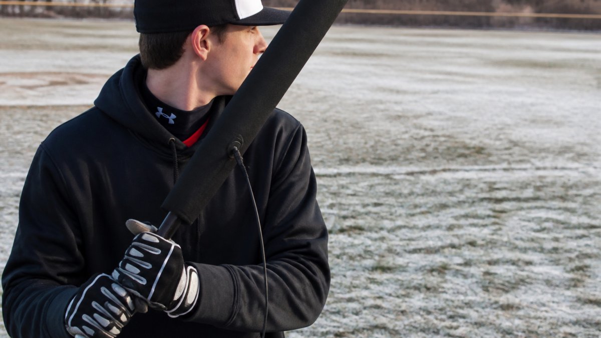 Diagram comparing the heating efficiency and design features of two baseball bat sleeves in cold weather conditions.