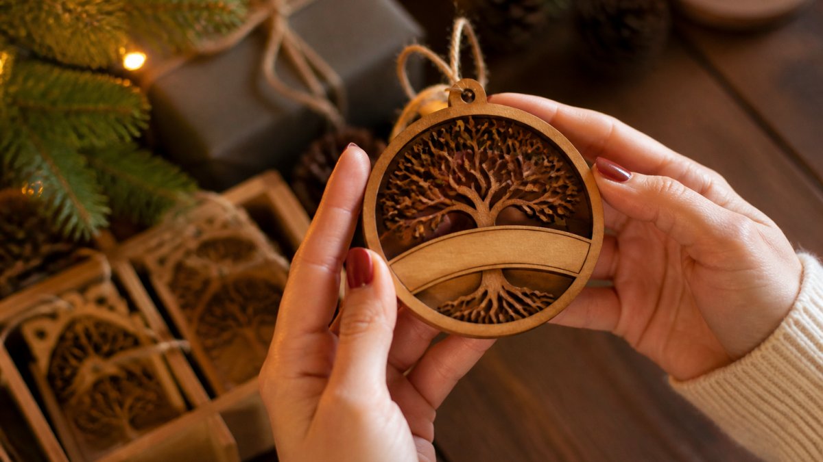 Close-up of hands holding a custom ornament with fine detail and personalized engraving, warm golden lighting highlighting the craftsmanship