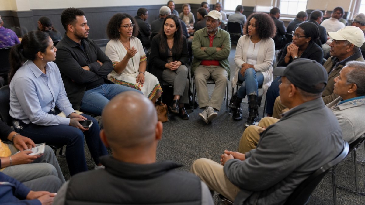 Diverse group of Ethiopian diaspora members engaged in respectful conversation at a community dialogue forum, with people of different ages and backgrounds seated in a circle, showing attentive listening and inclusive participation