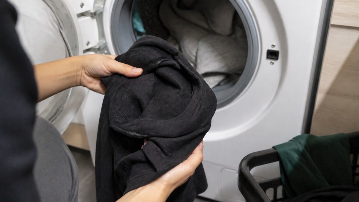 Step-by-step guide showing how to turn a graphic t-shirt inside out to protect the print during washing.