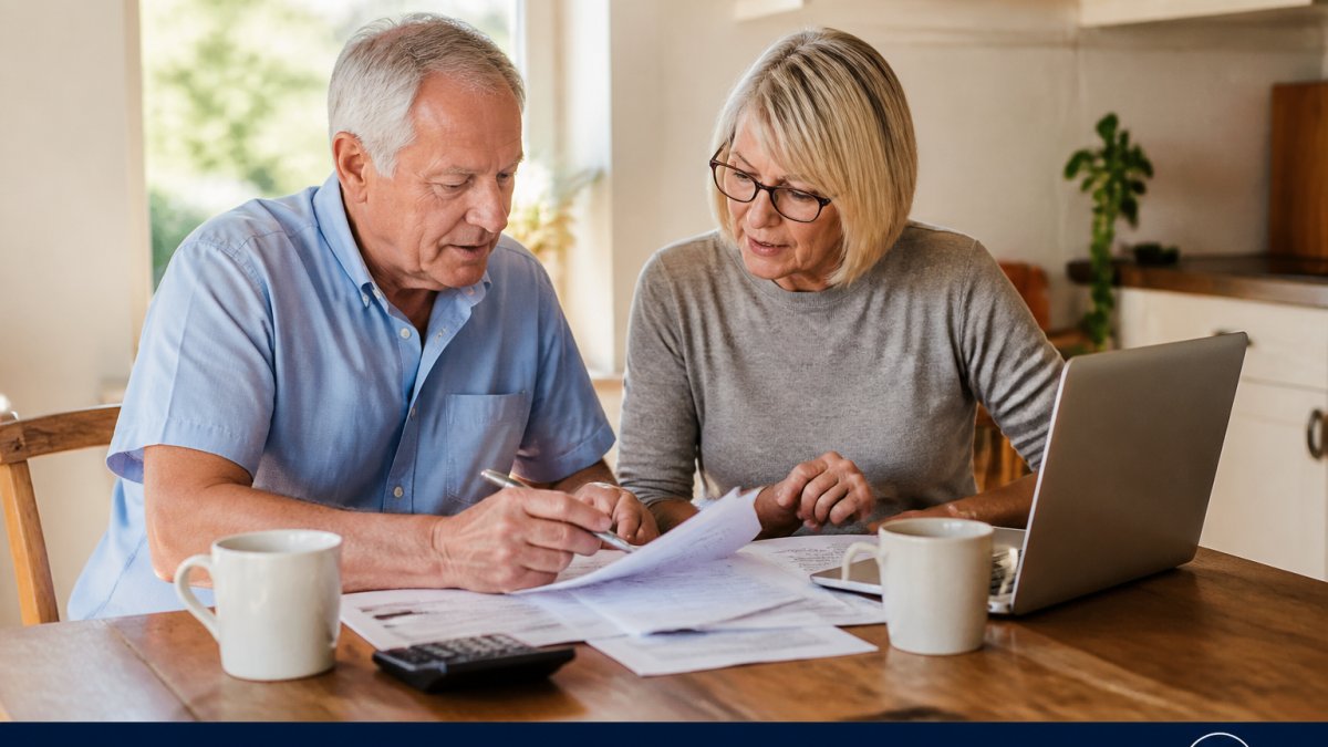 A retired couple reviews a chart showing how an annuity pay monthly plan changes based on their current age.