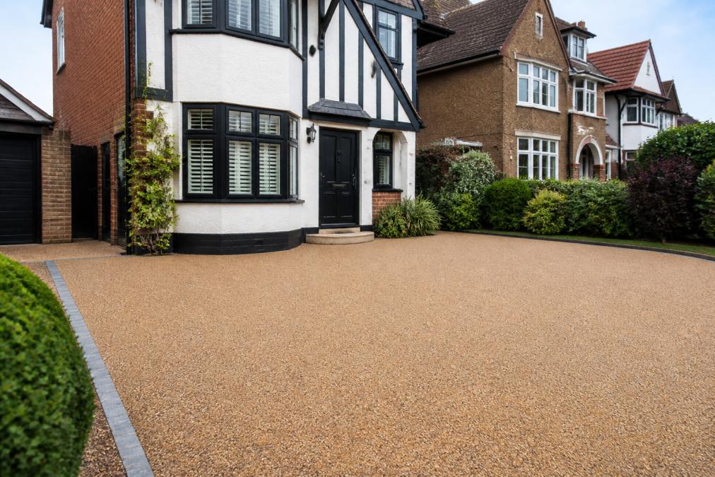 Modern residential driveway with smooth resin bound surface in warm neutral tones, showcasing clean aggregate finish and how it enhances the front elevation of a period home