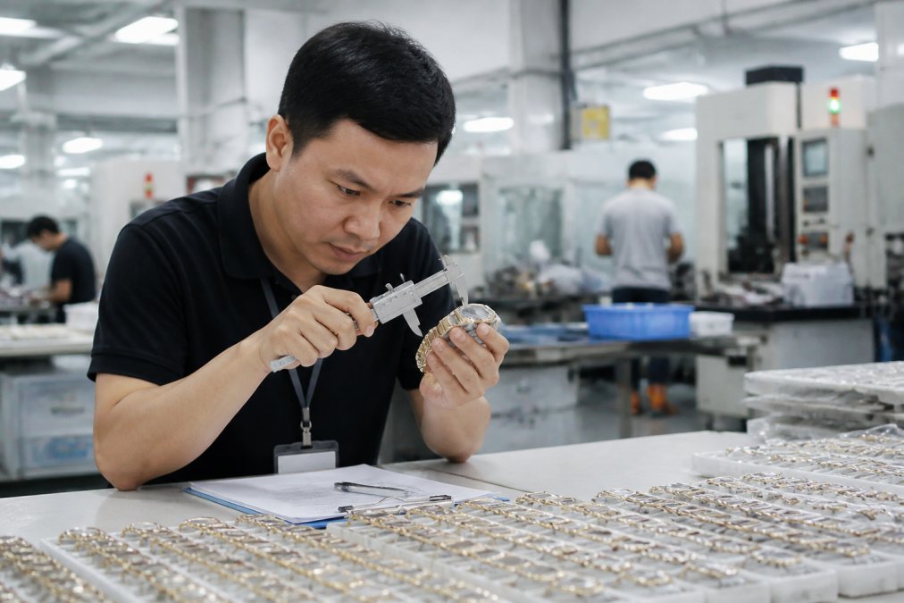 Quality inspector examining manufactured products on factory floor, using measuring tools and taking detailed notes on clipboard, with products and manufacturing equipment visible in background