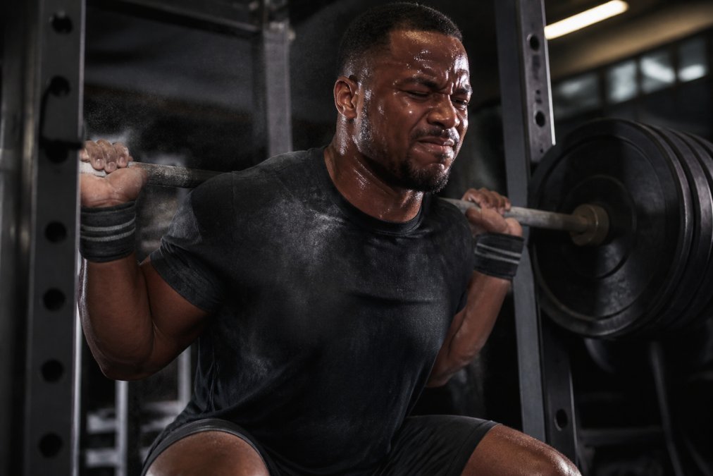Infographic illustrating the process of building resilience through fitness by overcoming heavy barbell challenges.