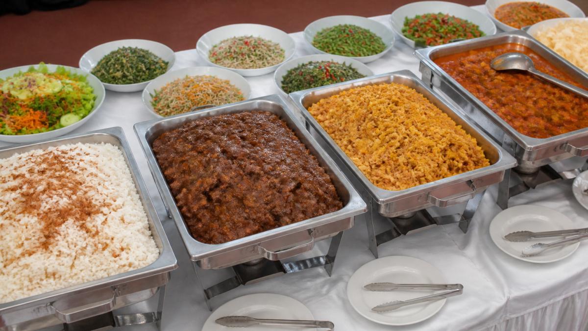 Generous Indonesian buffet spread for a large event to help you calculate catering portions accurately.
