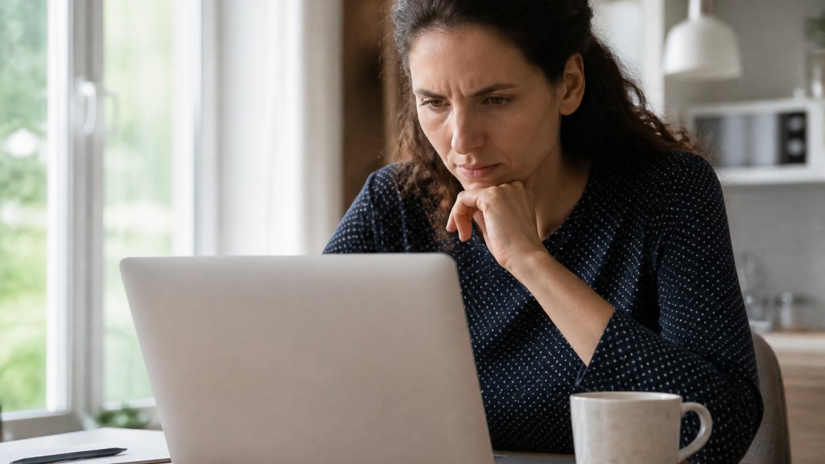 Concerned person at a desk reviewing a breach notification to check personal data exposure on a laptop screen