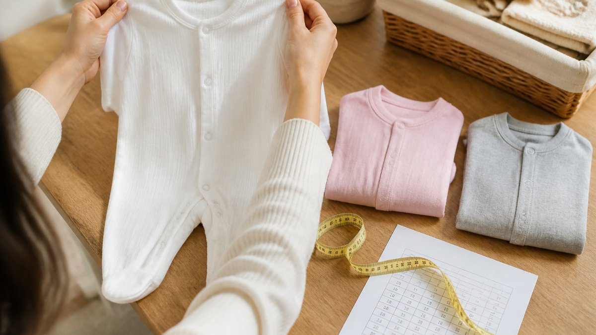 Infographic comparing size measurements for soft cotton newborn rompers in white, pink, and gray colors.