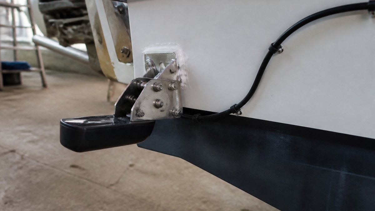 Transducer mounted on a boat transom with sealant as you learn how to connect fish finder to chartplotter.