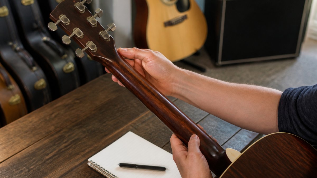 Step-by-step checklist for inspecting the neck and headstock condition of a used acoustic guitar