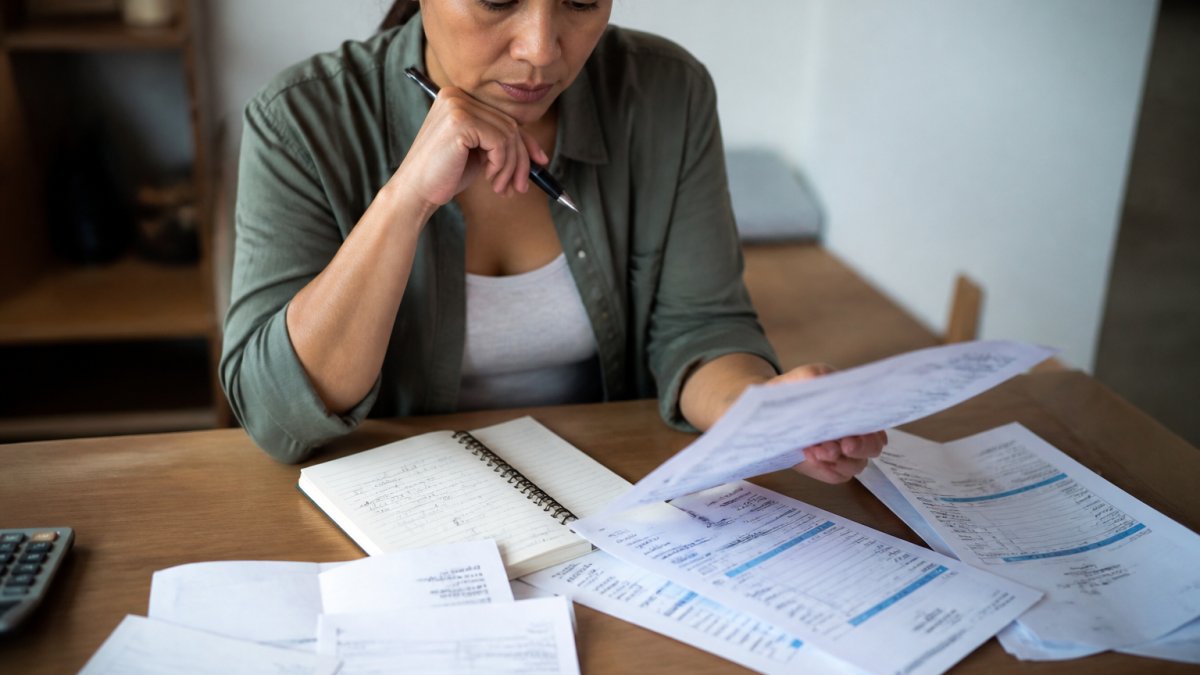 Person reviewing medical bills and insurance documents to learn how to dispute incorrect medical billing charges