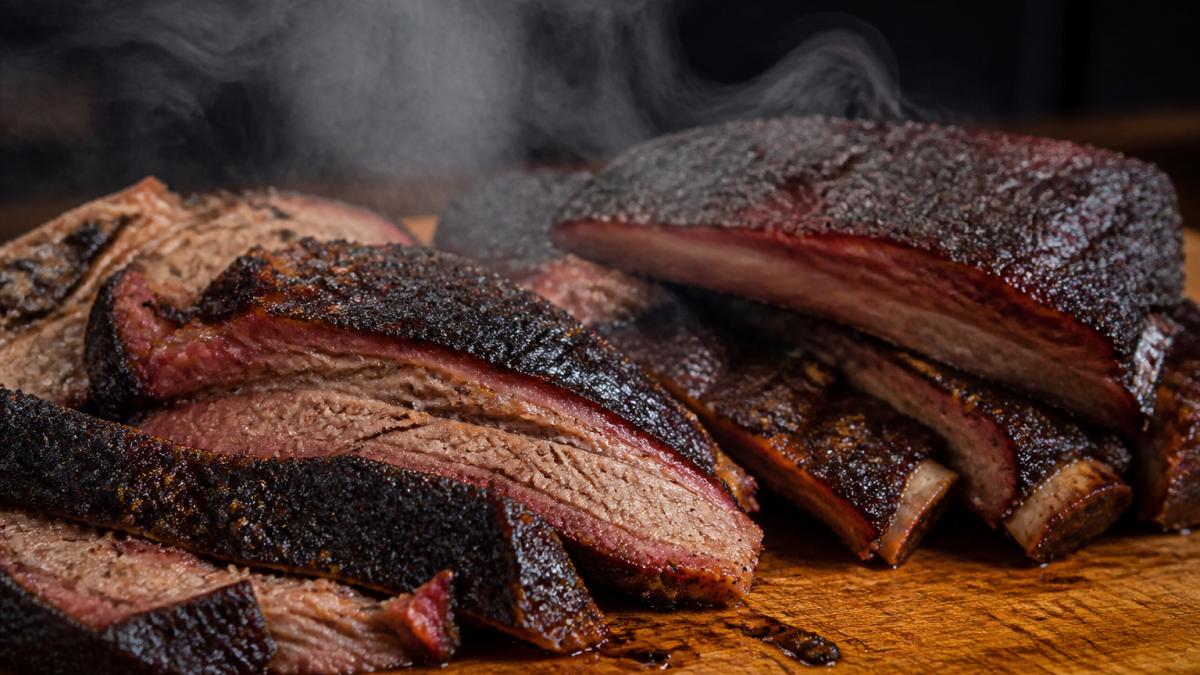 Infographic illustrating the visual markers of authentic BBQ joints using smoked brisket and ribs as examples.
