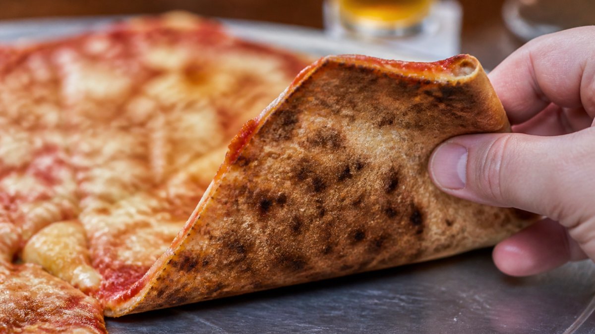 Diagram illustrating the key textures of authentic thin crust pizza including crispness, crunch, and chew.