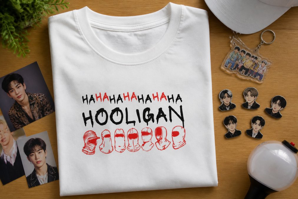 Close-up of custom printed K-Pop apparel showing vibrant graphic designs, enamel pins, and fan art merchandise arranged on a flat surface with natural lighting