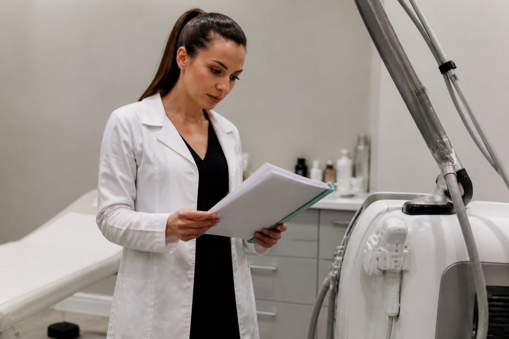 Medical professional reviewing advanced laser equipment specifications at the best laser clinic facility