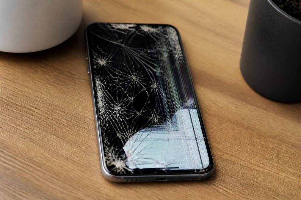 Professional illustration showing cracked phone screen
