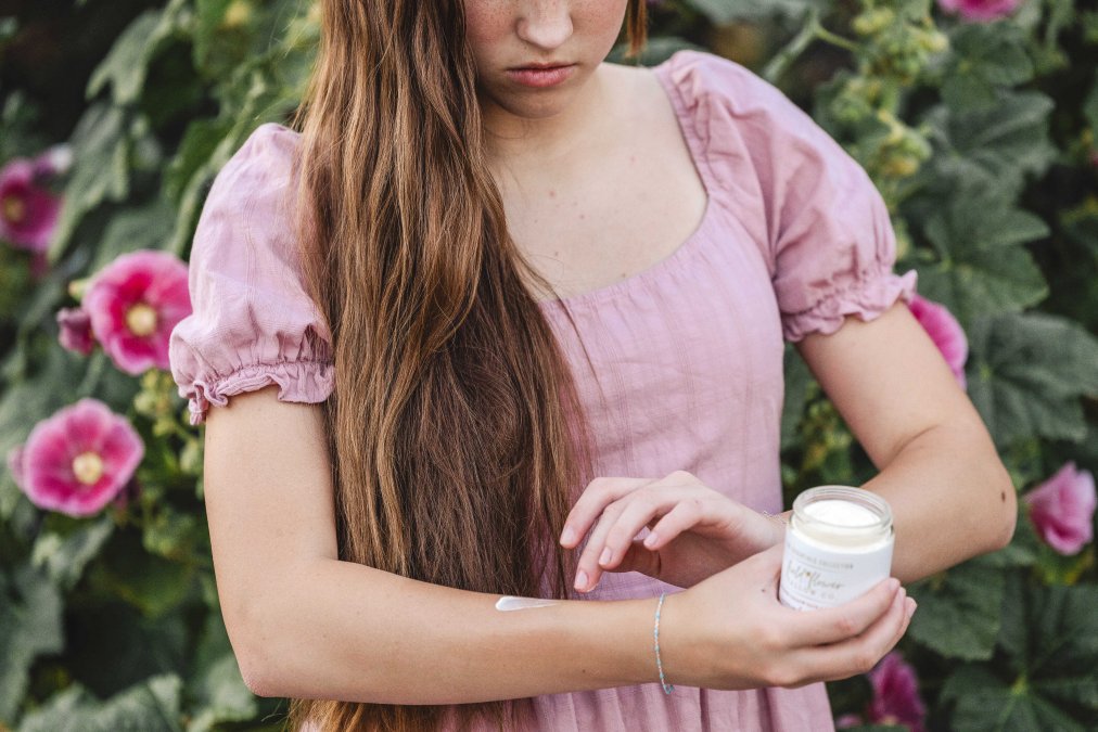 Woman applying tallow body balm