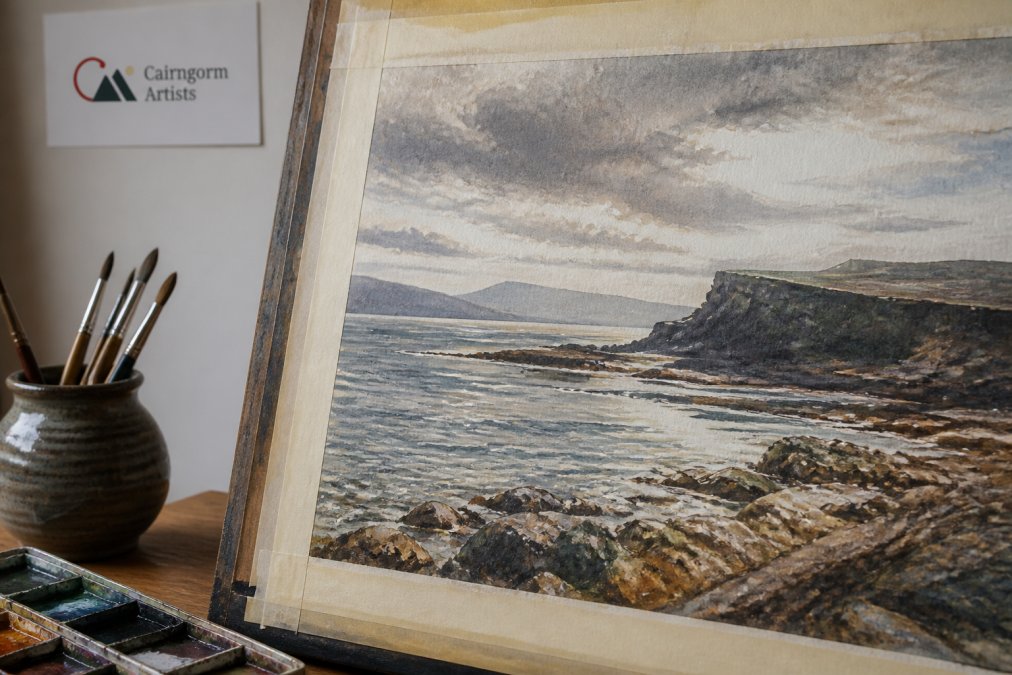 Close-up of an original Hebridean watercolour painting showing detailed brushwork with visible texture, layered coastal landscape elements, rugged island cliffs, and shifting light effects on water