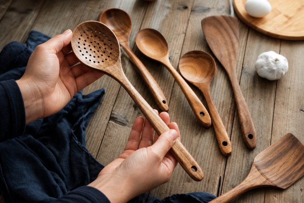 Examining the grain, texture, and finish of a wooden kitchen utensil
