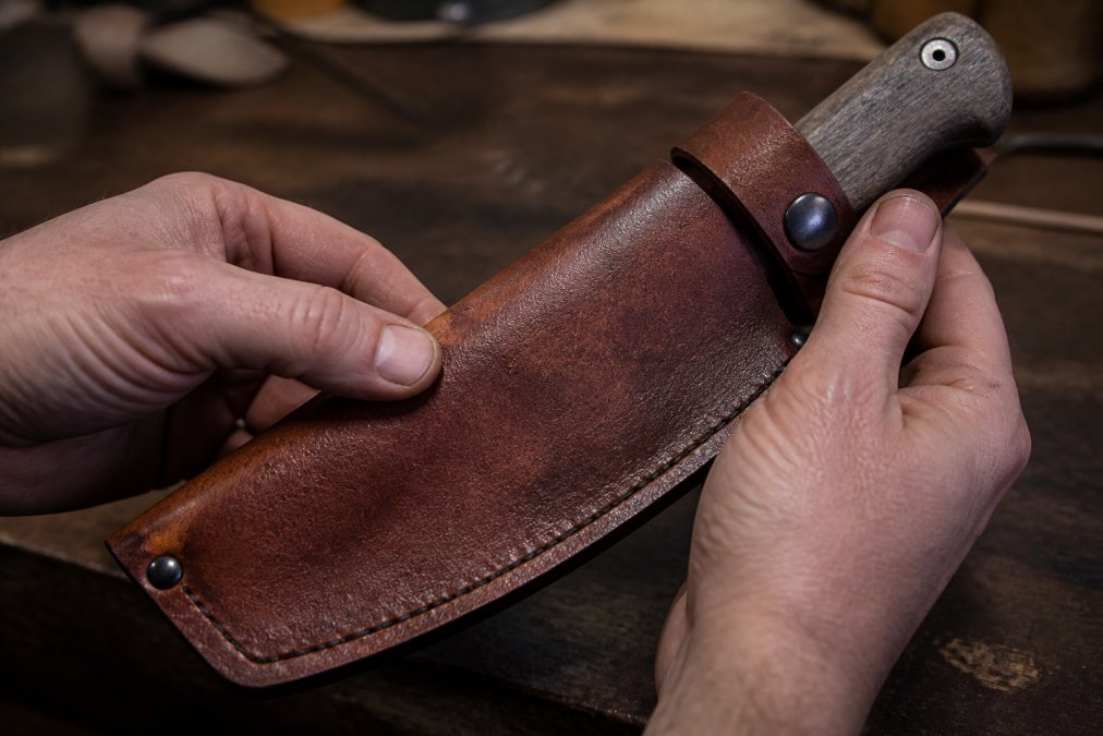 Diagram illustrating the natural grain and texture features to identify full grain leather on a hatchet sheath