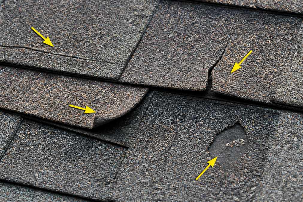 Infographic labeling hairline splits, edge cracks, curled tabs, and granule loss on cracked roof shingles.