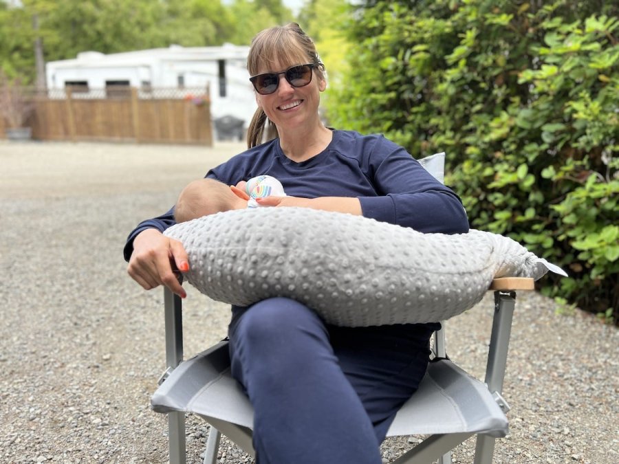 Mother breastfeeding her baby with a Luna Lullaby V-Shaped Nursing Pillow for comfortable feeding support