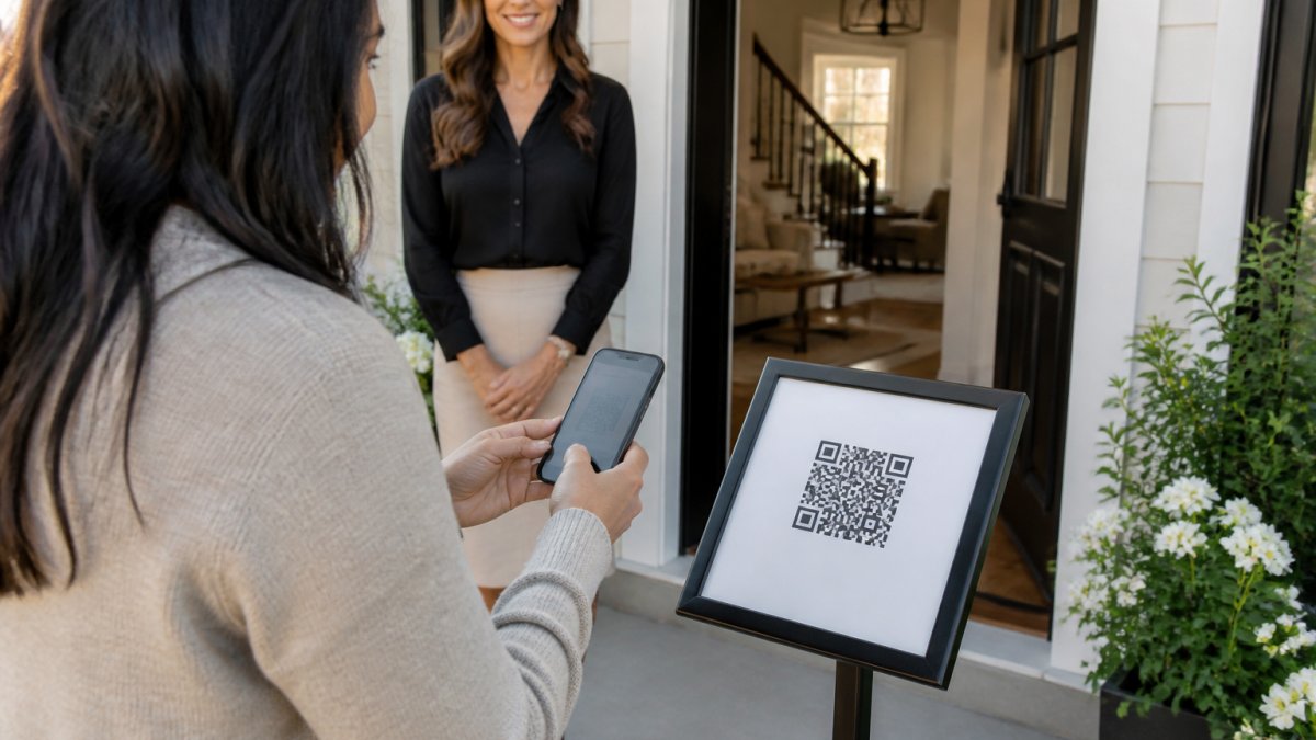 A real estate agent standing at an open house entryway, watching a prospective buyer scan a QR code on a sign with their smartphone, bright and welcoming home interior visible behind them