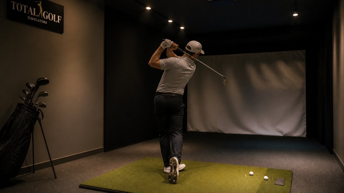 Golfer swinging on a mat under recessed ceiling lights in a home simulator room