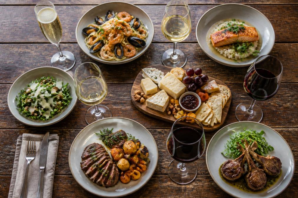 Infographic chart showing how to pair wine with food for meat, seafood, and cheese courses on a rustic table.
