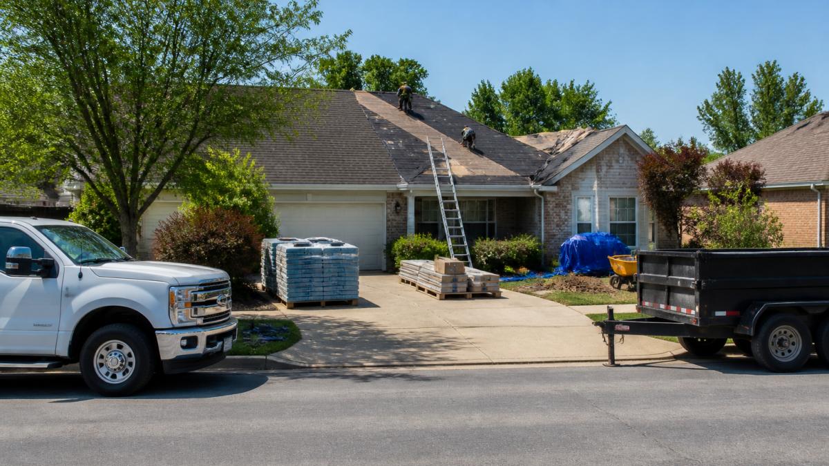 Residential driveway with vehicles parked on the street and contractor equipment staged in the yard showing proper clearance and work zone setup