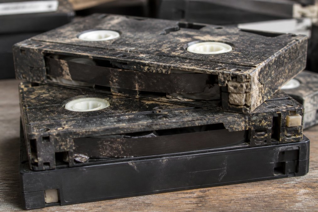 Infographic showing signs of mould, warping, and sticky residue to help you preserve degrading family tapes.