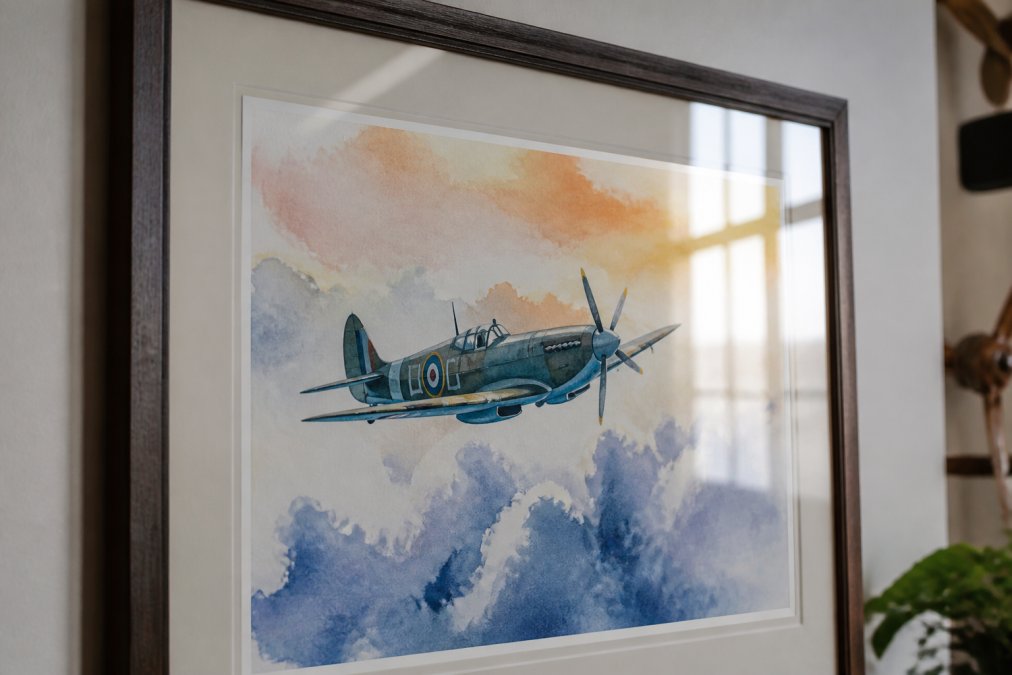 Close-up of a framed art print with UV-protective glass showing a vibrant watercolor painting with clear color saturation and depth, light reflecting off the protective glass surface