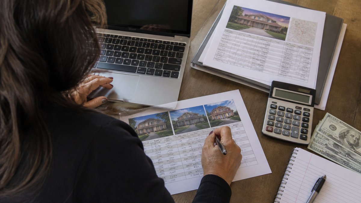 Real estate professional analyzing market data to price a home in Merced on a laptop at a desk