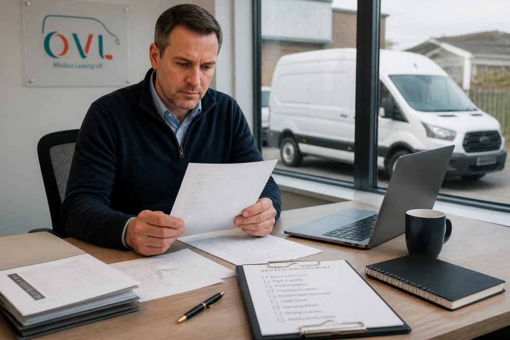 A fleet manager at a Northampton business reviewing vehicle leasing paperwork and a checklist on a desk beside a laptop, with a white van visible through the office window