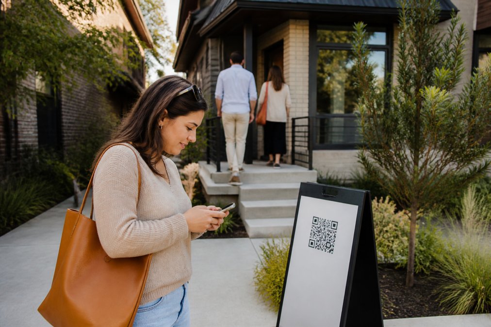 Real estate agent in a car checking a new lead on their phone to qualify real estate leads quickly.