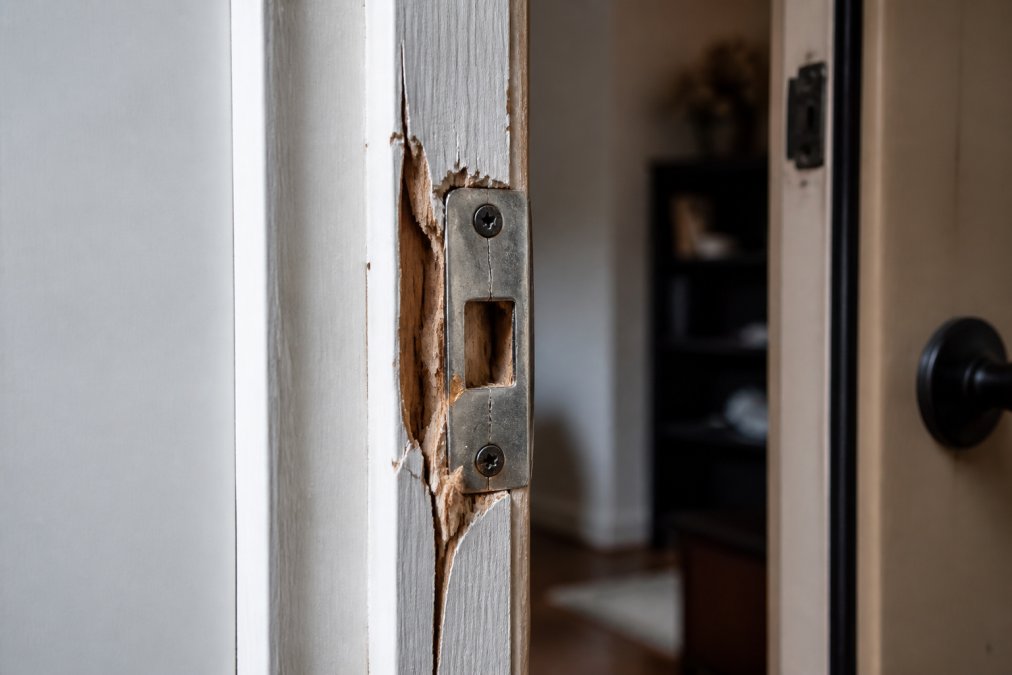 Diagram illustrating how to reinforce front door jambs damaged by a forced entry attempt with a splintered strike plate.