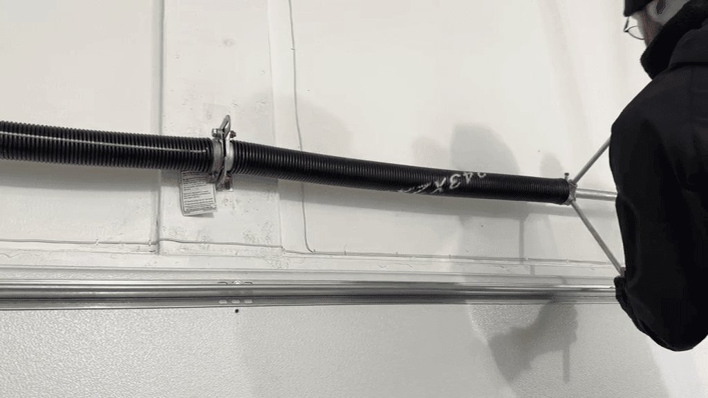 Wind up garage door spring according to specification to balance garage door