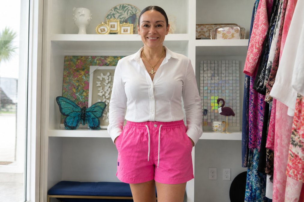 Woman wearing a structured blouse with defined waist and tailored pants, standing confidently in natural lighting, showing how proper fit and layering create a polished silhouette
