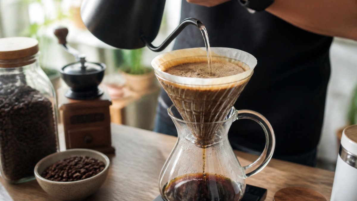 Hot water pouring over fresh coffee grounds creates a bubbly bloom, showing how to tell if coffee beans are fresh.