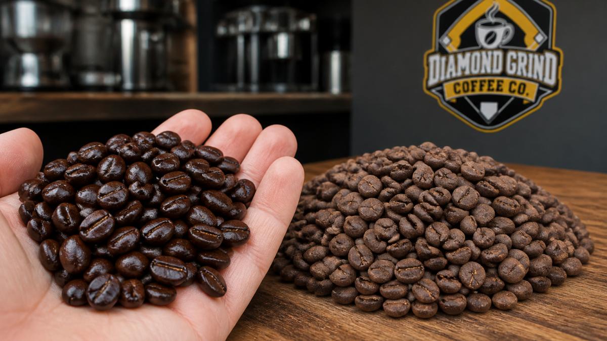 Close-up of a handful of glossy, dark whole coffee beans with visible surface oils and rich coloring, placed next to a pile of dull, flat-looking stale beans with no shine