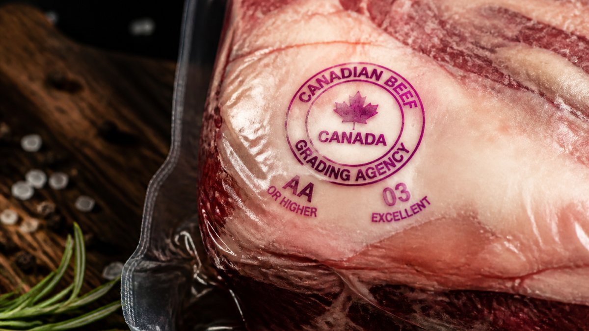 Close-up of a beef package showing the Canadian Beef Grading Agency purple stamp with grade designation, maple leaf symbol, and inspection details clearly visible on the packaging