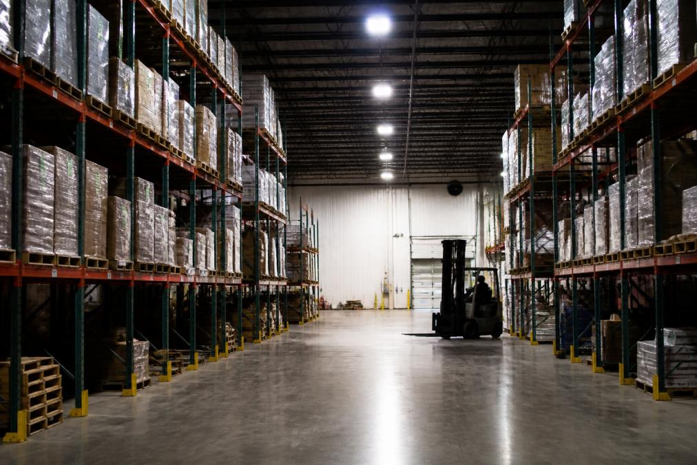 Diagram showing strategic LED fixture placement for improving warehouse safety with better lighting in aisles.