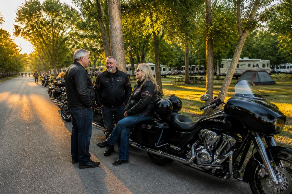 Group of Indian Motorcycle riders chatting at a scenic Wisconsin campground during an Indian motorcycle rally