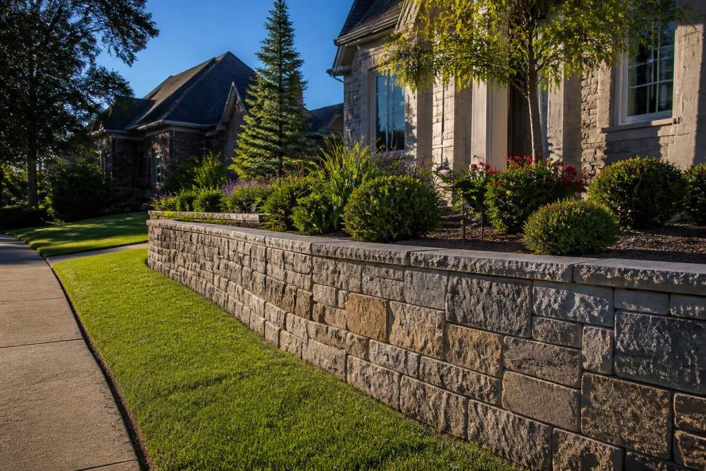 Infographic illustrating how a stone retaining wall increases property value and usable outdoor space
