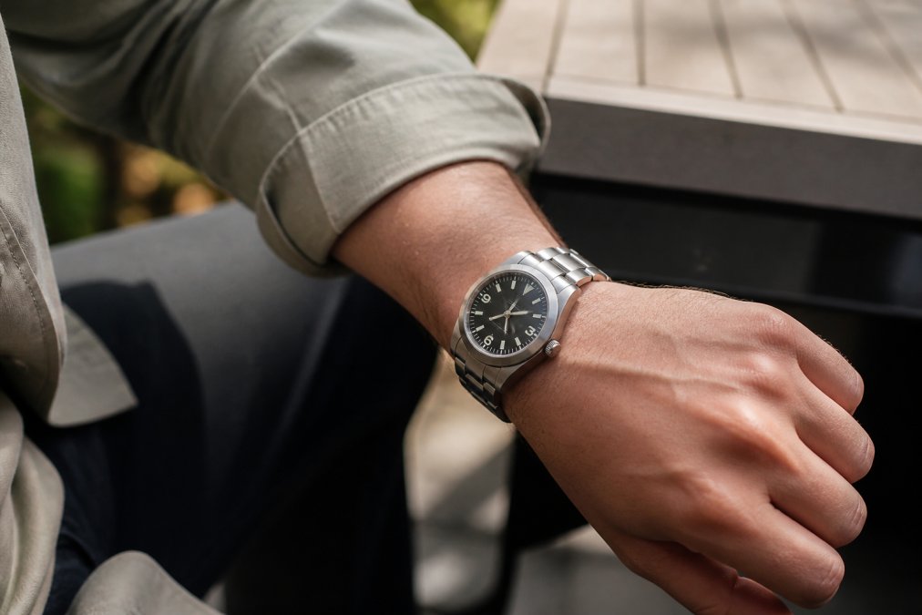 Titanium watch positioned on a wrist during casual daily activity, showing refined finish and comfortable fit in natural daylight